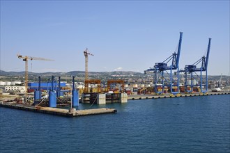 Construction cranes and container handling gantry cranes in the port of Civitavecchia