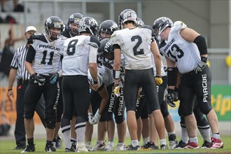 The team of the Prague Panthers stand in a huddle during an Austrian Football League game