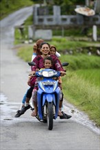 Woman with three girls on a motorcycle