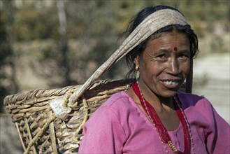 Female Nepalese farmer carrying a basket