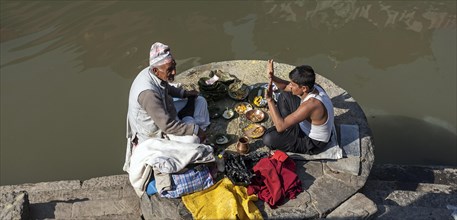 Two men praying at the Bagmati River