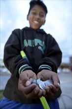 Street child with money earned from cleaning windshields