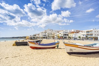 Colorful boats on the sandy beach in fishermen village of Armacao de Pera
