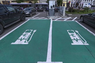 Green and white marked charging stations for electric cars