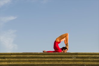 Young woman practising Hatha yoga