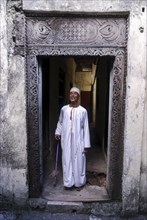 Proud Comorian man standing in doorway