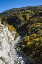 The caucasian mountains in fall with the Argun river
