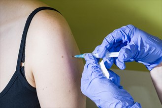 Injection of medicine into an arm