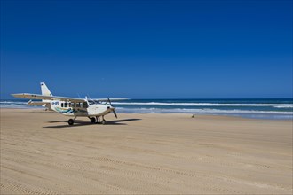 Small plane landing on the 75 Mile Beach