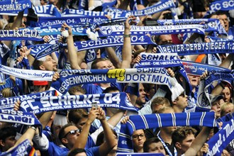 Schalke fans on the north stand holding up scarves