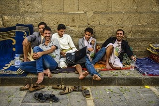 Men sitting in front of a house in the old city