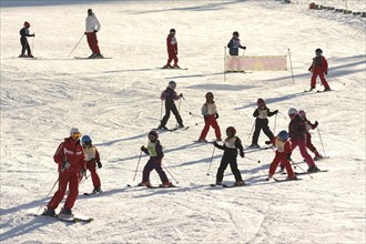 Children learning to ski at a ski school at a ski resort