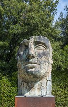 Head of a Roman giant sculpture by Igor Mitoraj in the Boboli Gardens or Giardino di Boboli