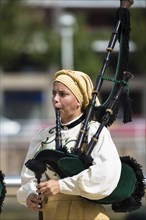 Musician in traditional costume playing the bagpipes