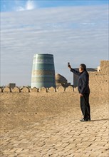 Uzbek man takes pictures of Kalta Minor Minaret