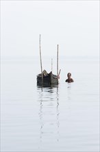 Cockle picker at his boat