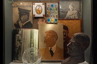 Showcase with Hitler portraits and bust