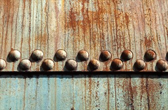 Rusted metal construction with rivets