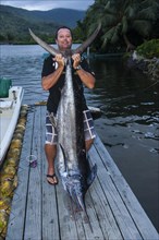 Man with huge sword fish