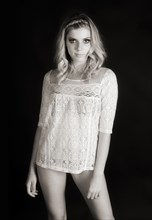 Young woman with braided hair wearing a lace top