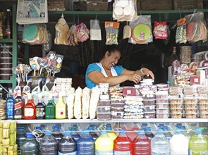 Woman selling sweets and drinks made from sugar cane