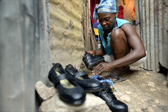 Woman shining the shoes of her children for their first day of school