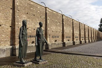 Sculptures of women in front of the Wall of Nations