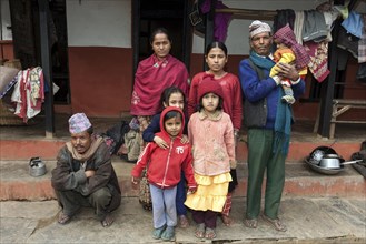 Nepalese family in front of their house
