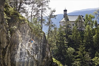 Sport climber climbing a rock face