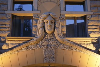 Sculpture of a woman's head over the Art Nouveau entrance of the Neiburgs Hotel