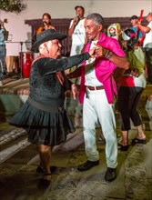 Elderly Cubans enjoying salsa dancing to the music of a live band