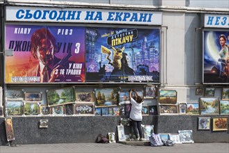 Pictures sales exhibition in front of a cinema