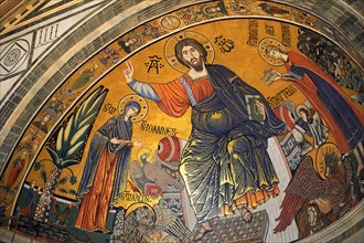 The medieval Romanesque style Byzantine mosaic of Christ between the Virgin Mary and St Minias