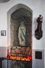 Virgin Mary with votive candles