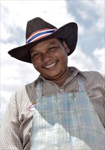 Smiling man with a hat and an apron