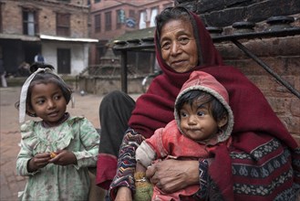 Elderly Nepalese woman with two children