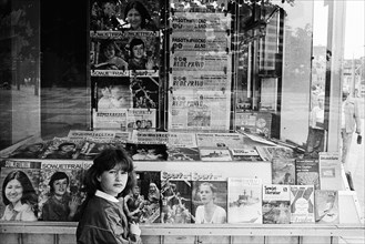 Girl in front of a kiosk of the Post-Zeitung Vertriebes PZV of the GDR in Dunkerstrasse