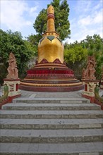 Golden pagoda in the outdoor area of the Buddhist monastery Brahma Vihara