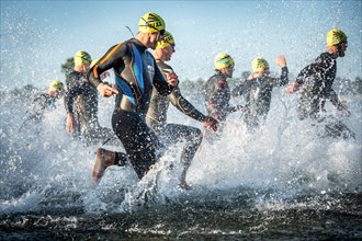 Participants of the Ironman Triathlon starting the race in the surf