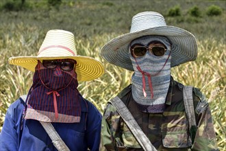 A man and a woman wearing sun protective clothing