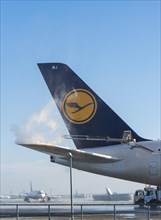 Tail fin of a Lufthansa Airbus A380-841 during deicing at Frankfurt Airport
