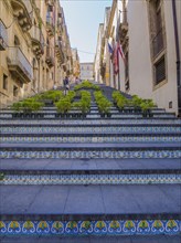 The Santa Maria del Monte staircase with ceramic tiles and potted plants