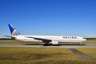 United Airlines Boeing B 767 rolling on the taxiway towards runway