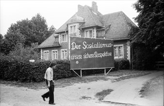 Agitation board in front of a building of the hospital Buch