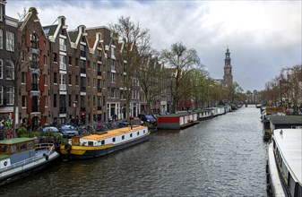 Houseboats on Prinsengracht with Westerkerk tower
