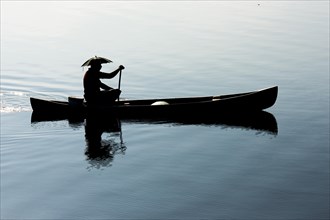 Fisherman in a small wooden boat