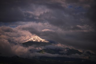 Snow-capped Mt Rosskogel with looming clouds