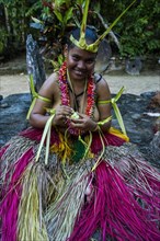 Traditionally dressed islander making traditional art work