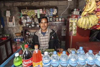 Nepalese seller in a small food store in Sauraha