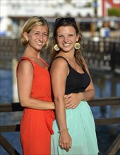 Two young women posing on the redesigned promenade of Playa Blanca